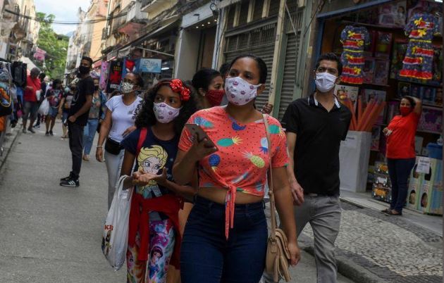 أشخاص يضعون كمامات يسيرون في شارع تسوق في ريو دي جانيرو يوم 29 يونيو 2020. تصوير: لوكاس لانداو - رويترز